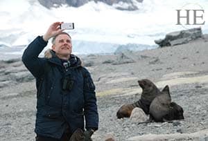 a gentleman takes a selfie with two lazy seals