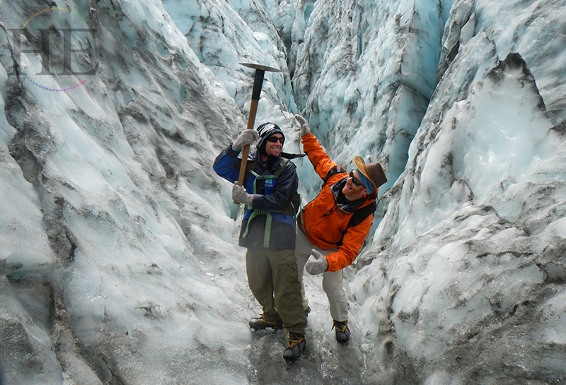 Two men standing on Fox Glacier on HE Travel's Wild Kiwi New Zealand Adventure tour.