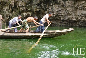rowing the boats through the river on the HE Travel gay China cultural tour