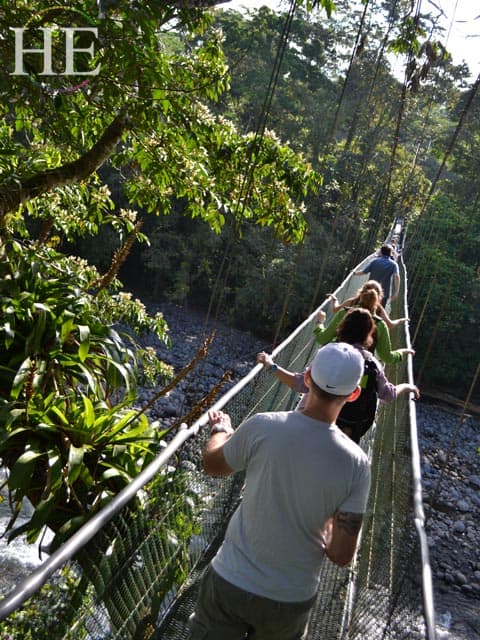 crossing a rope bridge on the HE Travel gay adventure in Costa Rica