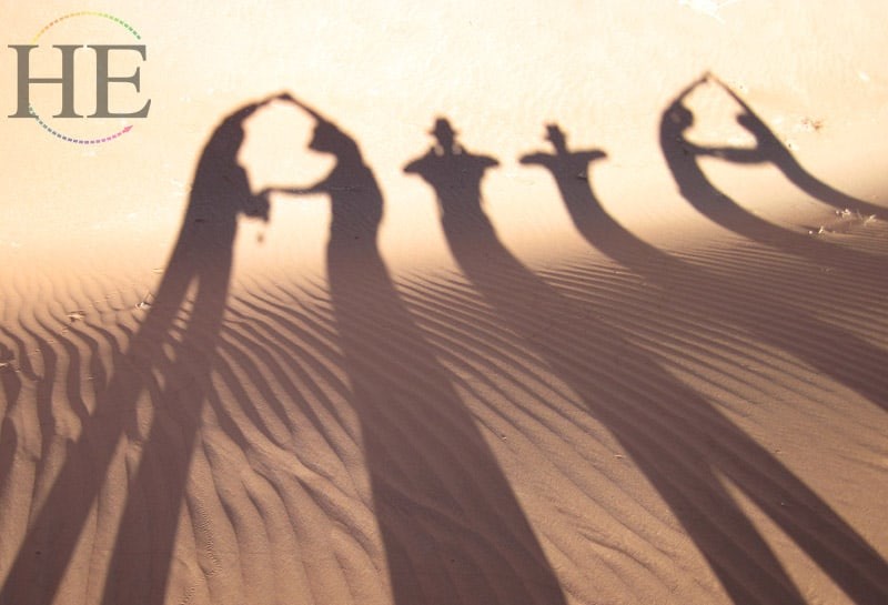 silhouettes on the dunes write ATTA