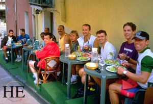 biking group eats lunch on the cafe steps on HE Travel Mistral gay biking tour in France