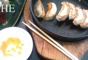 enjoying gyoza potstickers on Kauai Hawaii with HE Travel gay adventure tour