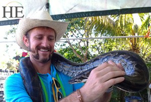 zach moses handles a snake on the HE Travel gay key west adventure tour