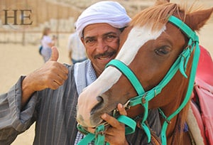 a local man and his horse giving the thumbs up