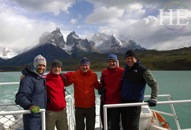 handsome group of men with the horns in the background on the HE Travel gay adventure in patagonia Chile