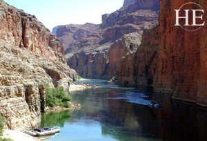 a long view of the colorado river and the boat on the HE Travel gay adventure Grand Canyon