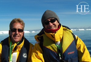 Two men in bright yellow coats are happy on the HE Travel gay Antarctica Adventure