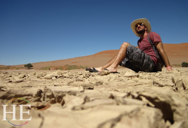 Zachary Moses peers into the sun in Namibia - HE Travel