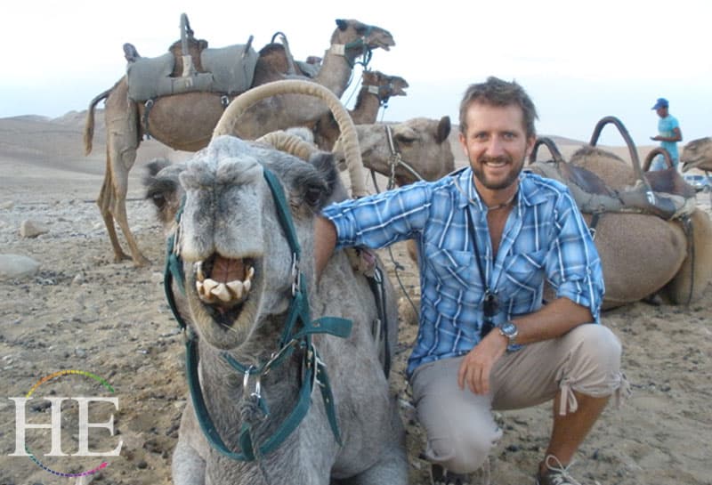 Zachary Moses with a camel on the HE Travel gay adventure in Israel