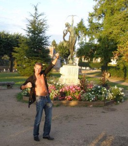 tour guide Charly mimics a statue on the HE Travel gay France bike tour
