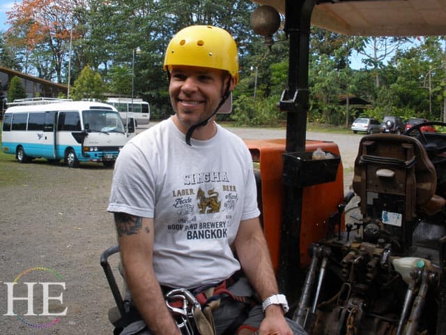 guy in yellow hat read to zipline on the HE Travel gay adventure in Costa Rica