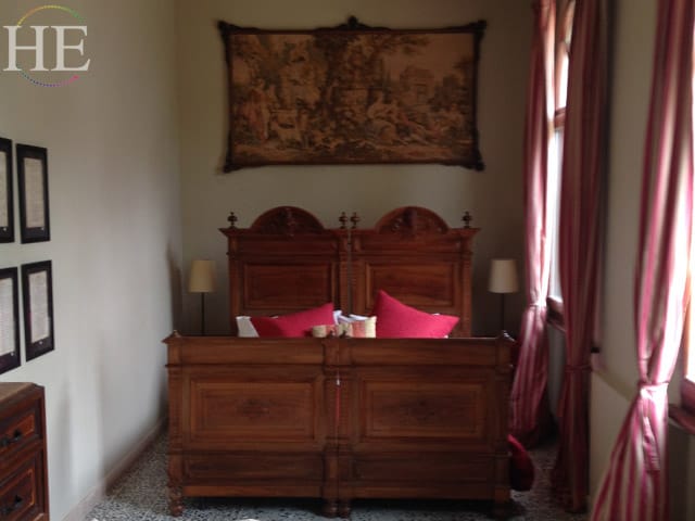 pink striped curtains and a beautiful wood bed on the HE Travel gay italy bike tour in puglia