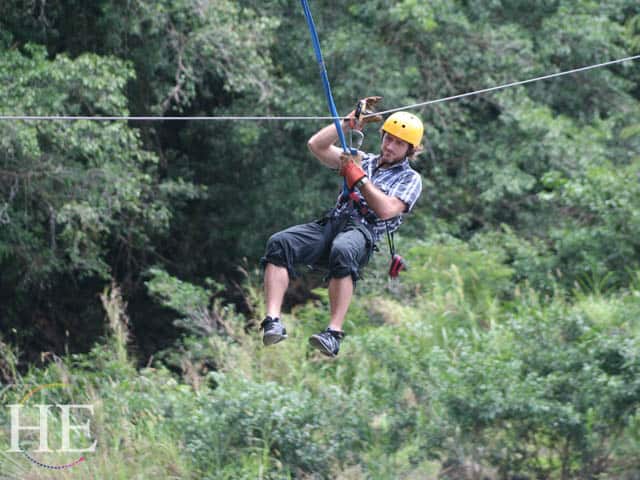 Zachary Moses ziplining on the HE Travel gay adventure in Costa Rica