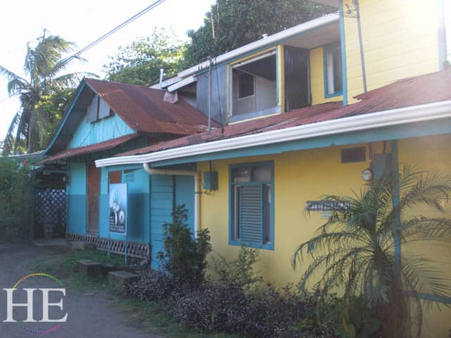 a turquoise and yellow house on the HE Travel gay adventure in costa rica