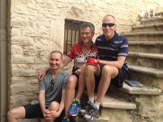 cute bikers take a rest on an ancient staircase on the HE Travel gay italy bike tour in puglia