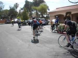 cyclists leave the parking lot on the HE Travel gay Arizona bike tour