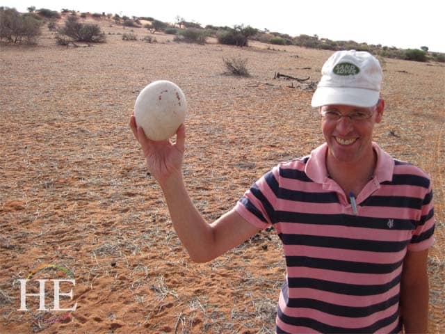 Jens CEO of African Bikers in Namibia holds a huge egg - HE Travel