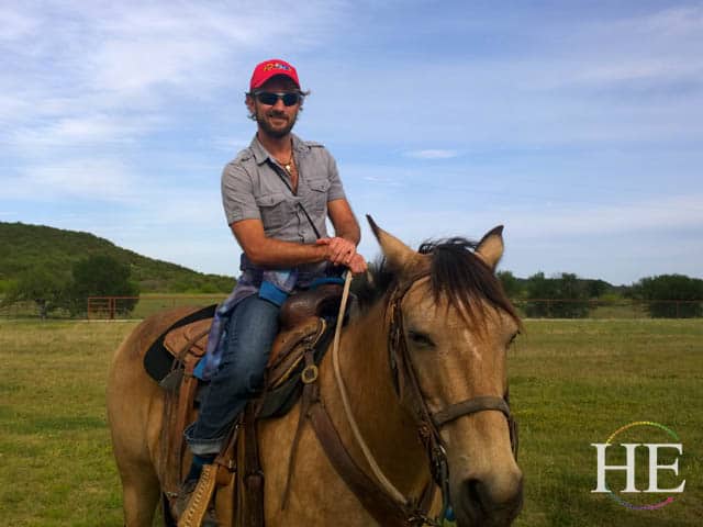 Gay Travel Expert Zachary Moses Sits on top of a horse he just got control of