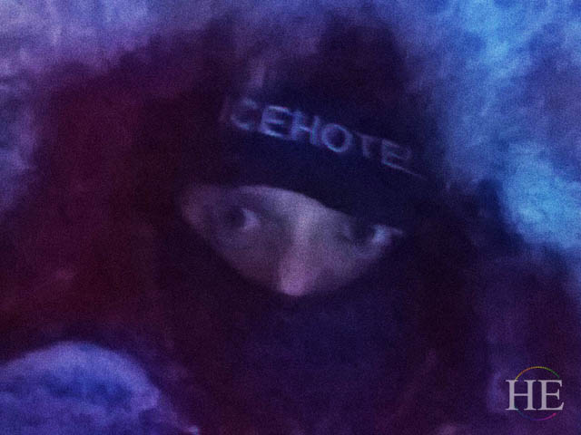 Zach is bundled up on his way to the ice hotel