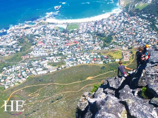 zachary moses looks off the cliff at the terrifying drop off table mountain before his abseil