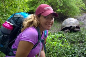 Trisha Ashcraft posing next to a giant tortoise smiling