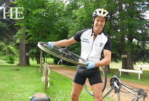 Our guide changes a tire in France on the HE Travel gay bike tour of Dordogne