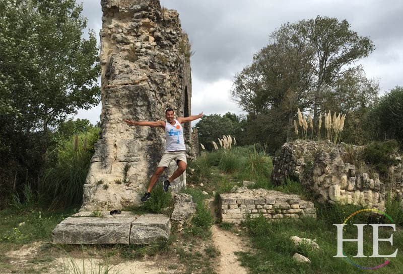 kaleb jumping around some ruins on the Provencal bike tour