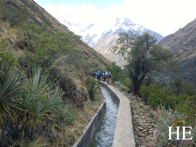group hikes along an aqueduct that brings water from the salkantay glacier into the villages