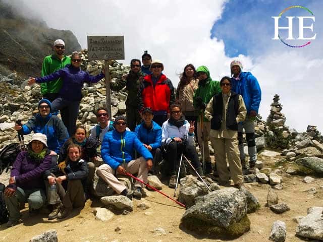 he travel group sits at top of salkantay glacier summit in peru