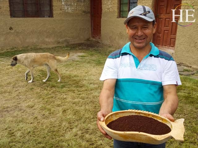 local Peruvian farmer holds fresh ground coffee beans