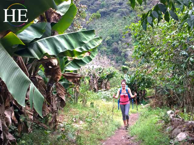 iris serbanescu hikes through a mountain village in peru on her way machu picchu
