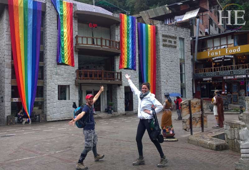 zach moses, iris serbanescu in machu picchu town, lots of rainbow flags cuzco flags