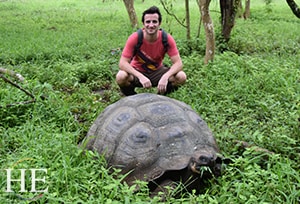 a giante tortoise munches leaves on the Gay Galapagos adventure with HE Travel