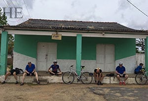 some tired cyclists take a break in cuba