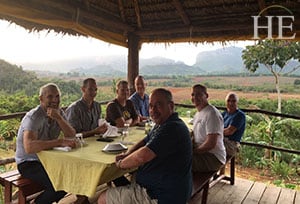 a group enjoys a meal with a beautiful backdrop in cuba