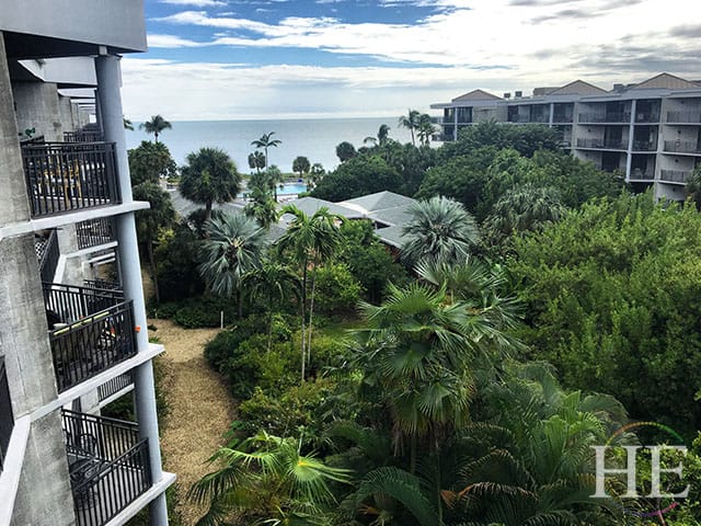 View of the lush tropical garden and ocean from a penthoues balcony.