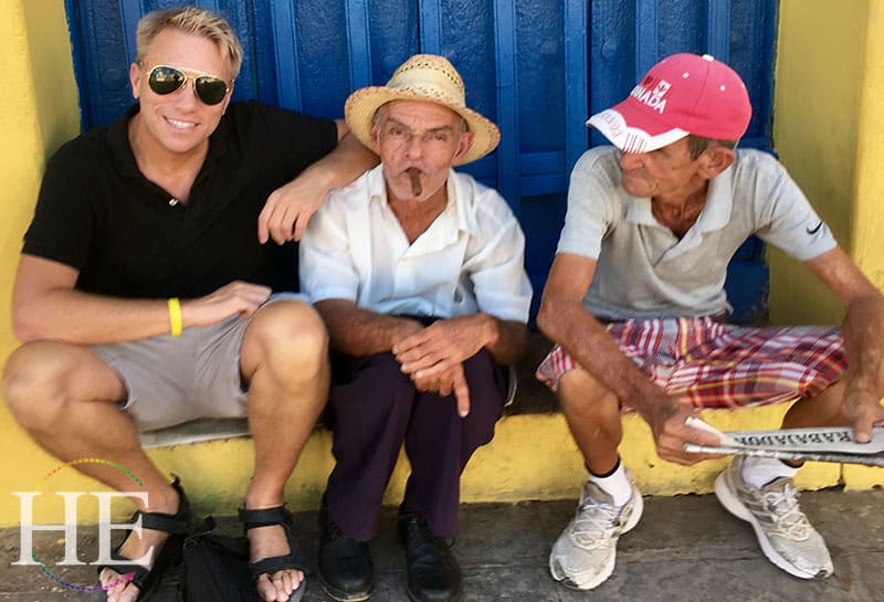 cary harrison poses with locals in cuba