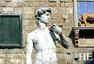 a statue of david against a cobbled backdrop in florence italy