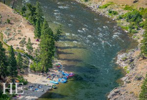 birdseye view of the kayaks sitting riverside on the HE Travel gay rafting whitewater adventure in Idaho
