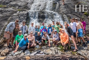 our group poses for a waterfall picture on the HE Travel gay rafting whitewater adventure in Idaho