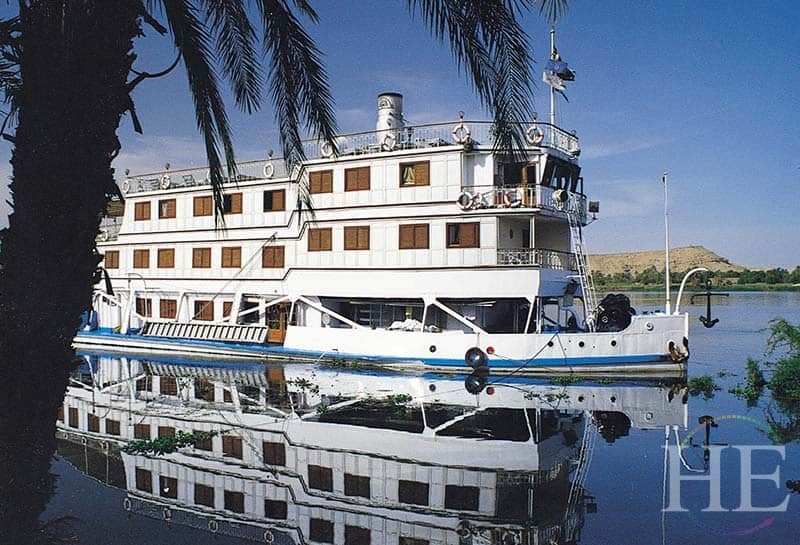 the ss karim hides behind tree fronds on the nile river