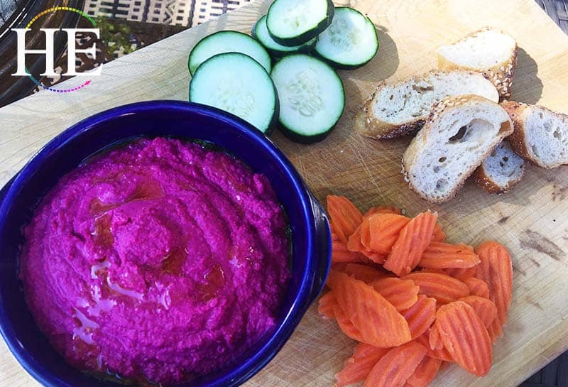 homemade roasted beet hummus with cut veggies and baguette