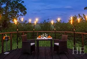 romantic torchlit dinner overlooking verdant garden at ulagalla resort in sri lanka