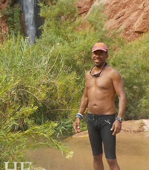 david kelly stands in front of a beautiful waterfall on the splash grand canyon gay rafting adventure tour