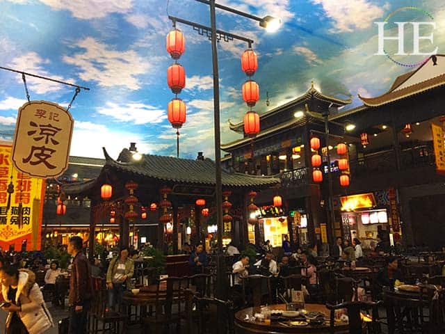 a bustling indoor market below a sky mural ceiling in zhengzhou china