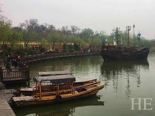 replica boats sit quietly in a river in kaifeng city china