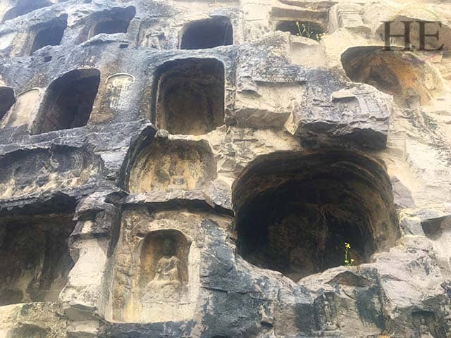 hundreds of intricately carved buddha caves at longmen grottoes in luoyang china