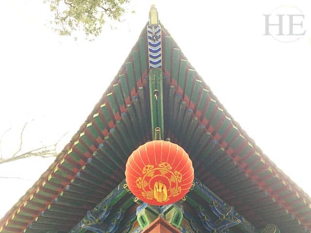 brightly painted pagoda and red hanging lantern at the shaolin temple in china
