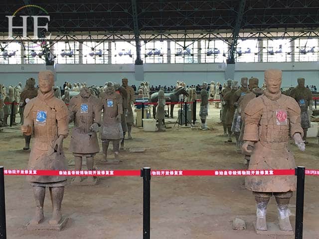 terracotta soldiers being repaired at the terracotta army pits in xi'an china